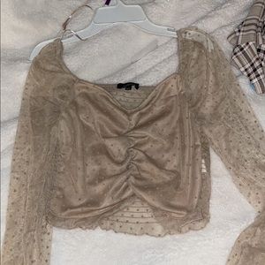 long sleeve mesh top. definitely a nude color.